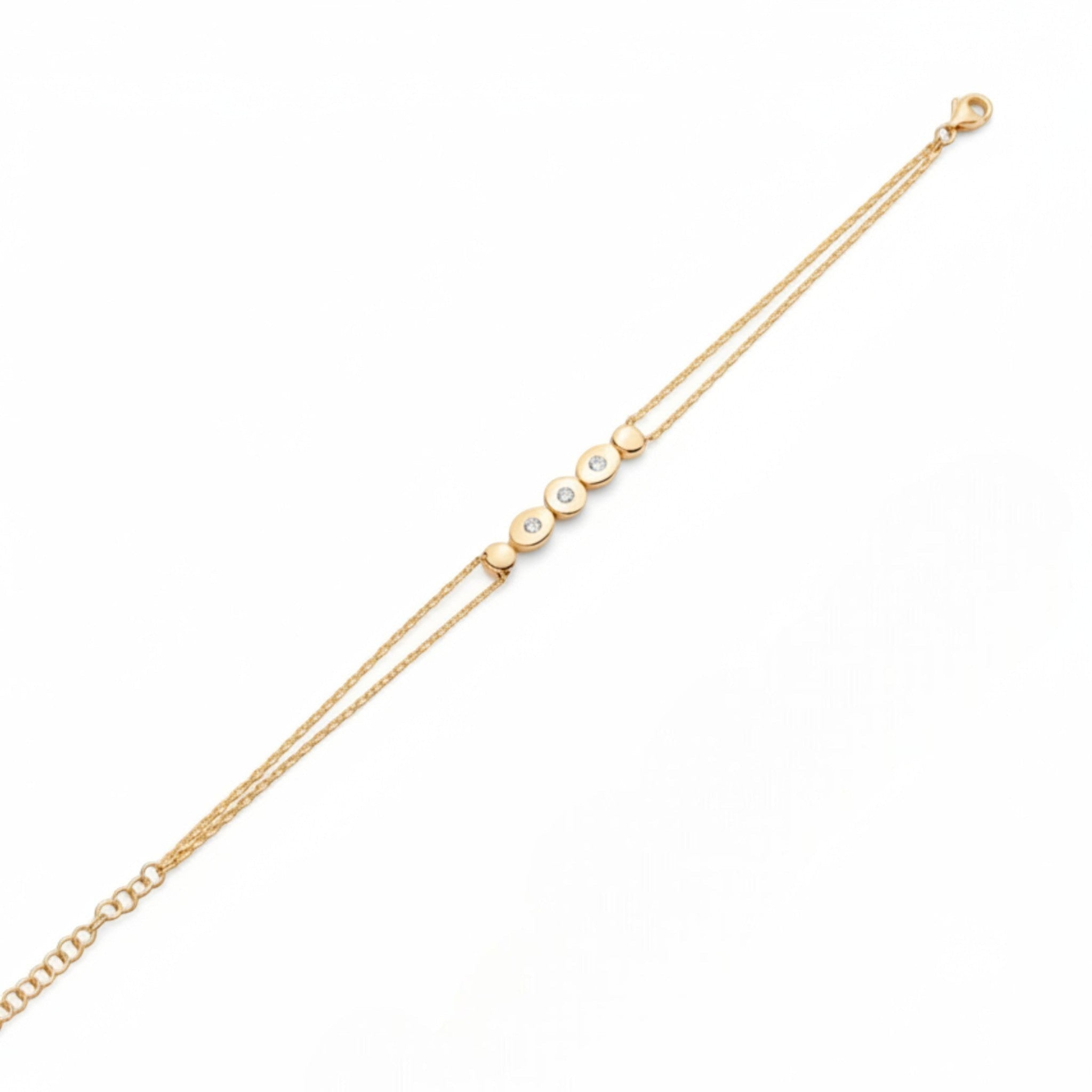 Tania Claire Australia gold double chain bracelet with five circular charms, three set with sparkling stones.