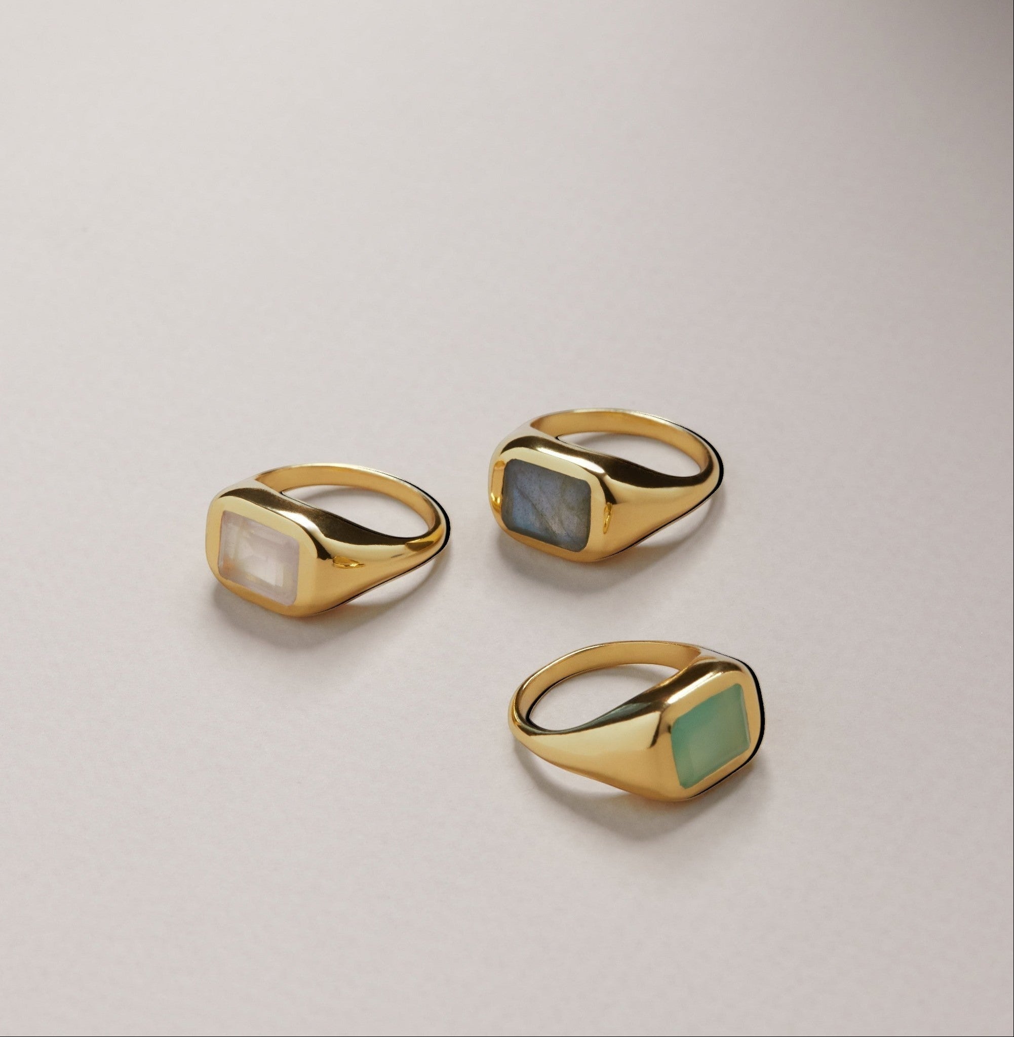 Tania Claire Australia gold signet ring with a rectangular rose quartz gemstone. Modern sculptural design.