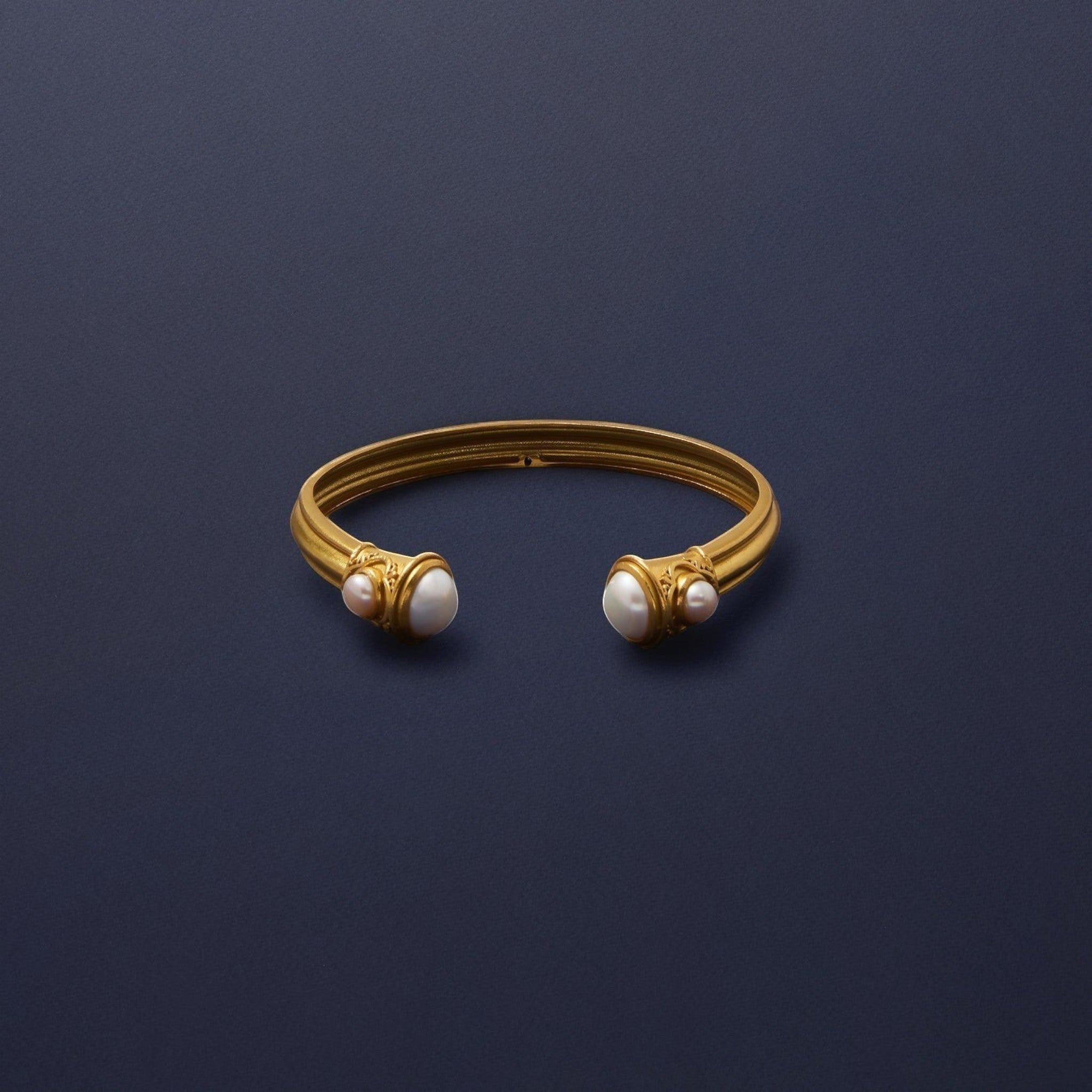 Tania Claire Australia gold cuff bracelet with freshwater pearl accents. Open cuff design with sculptural details.