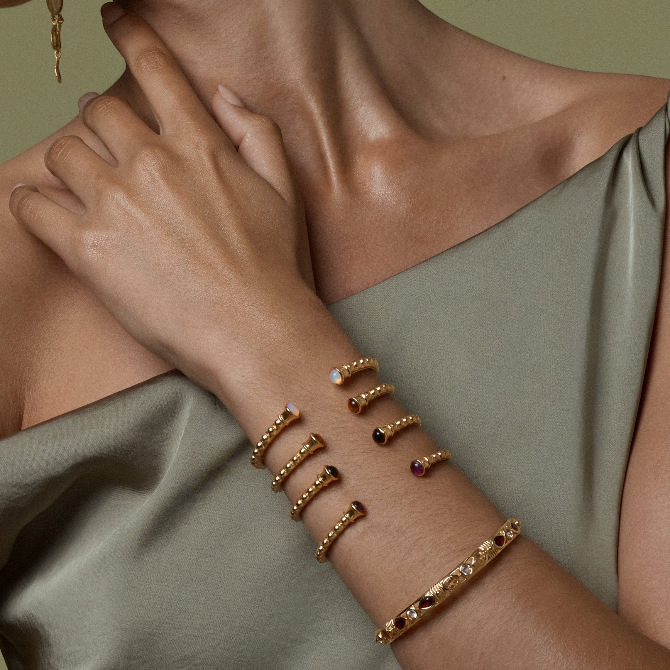 Tania Claire Australia gold vermeil Inner Flame bangle with garnet and crystal accents, inspired by feminine strength.