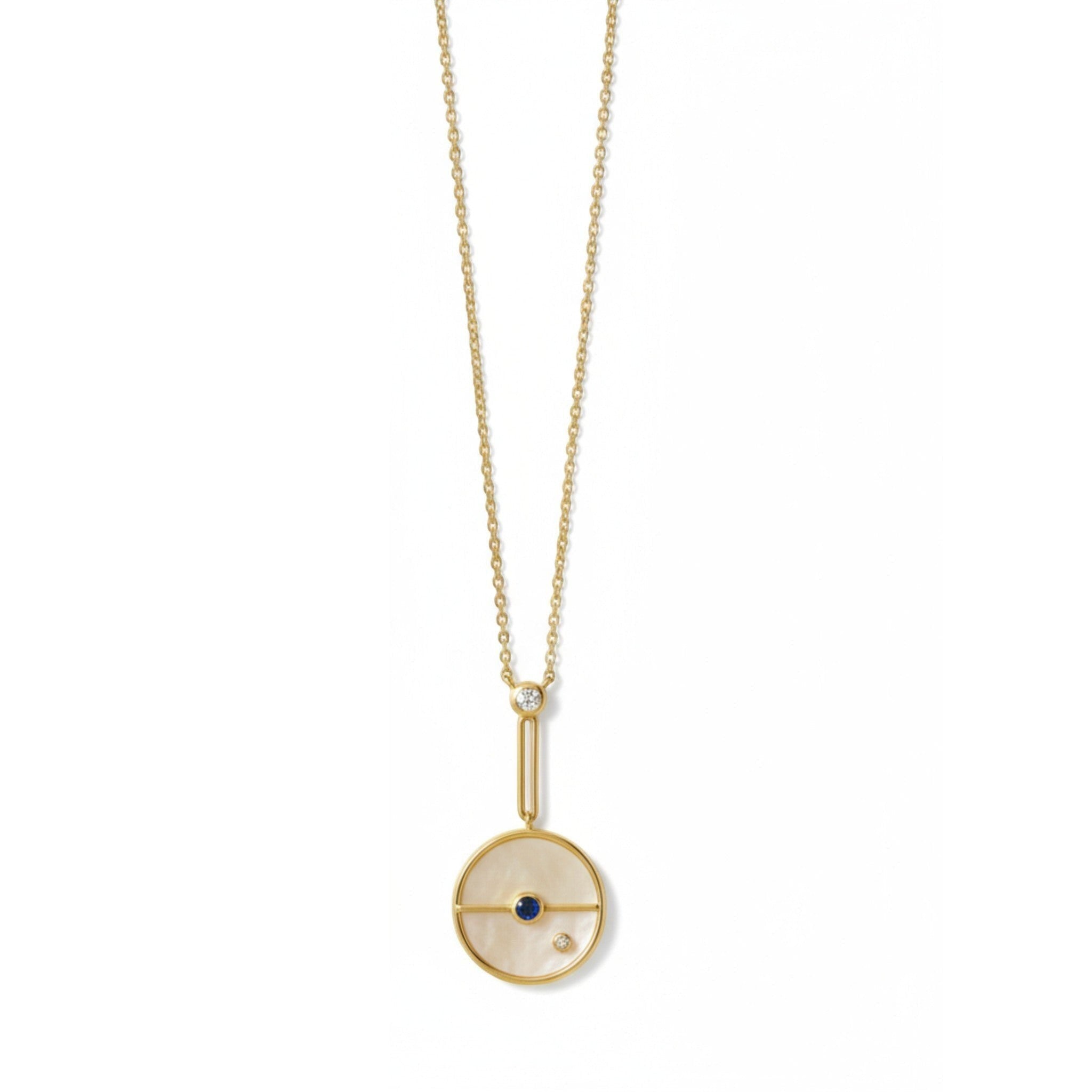 Tania Claire Australia 14K gold necklace with mother-of-pearl disc, sapphire, and diamond accents.