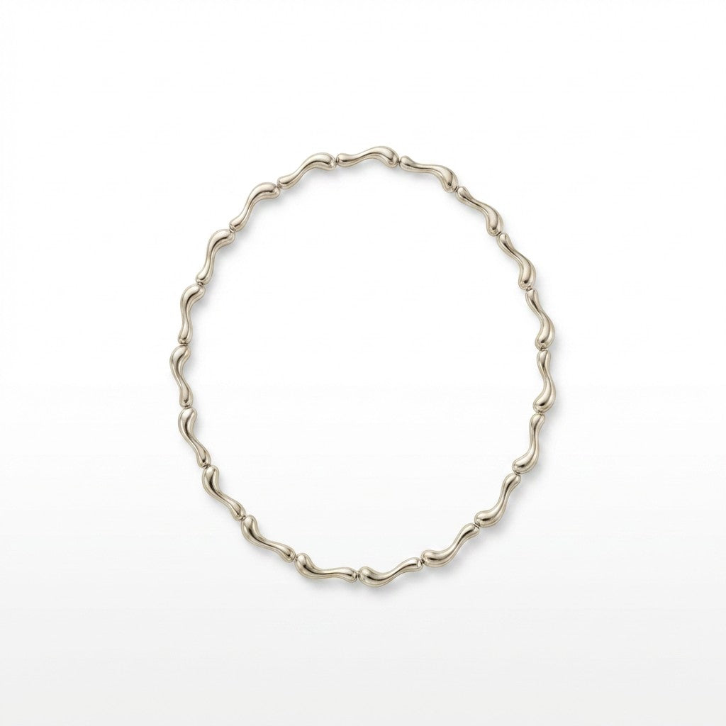 Tania Claire Australia Ocean Spine Necklace in sterling silver, featuring sculpted wave-like links for a fluid, coastal-inspired design.