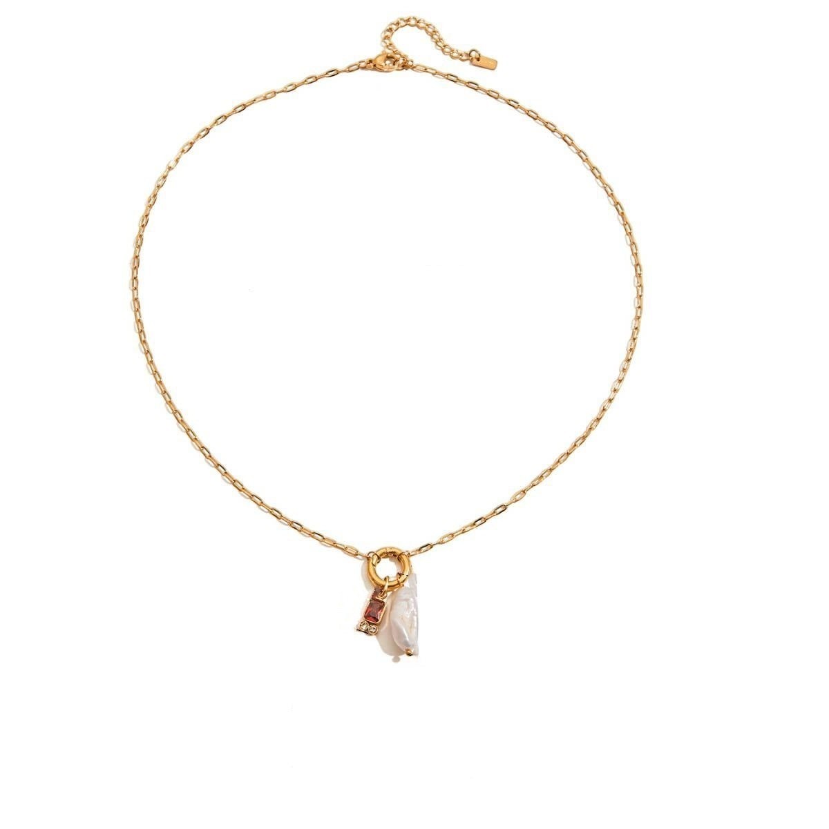 Tania Claire Australia gold plated stainless steel necklace featuring a lustrous pearl and a red birthstone charm.