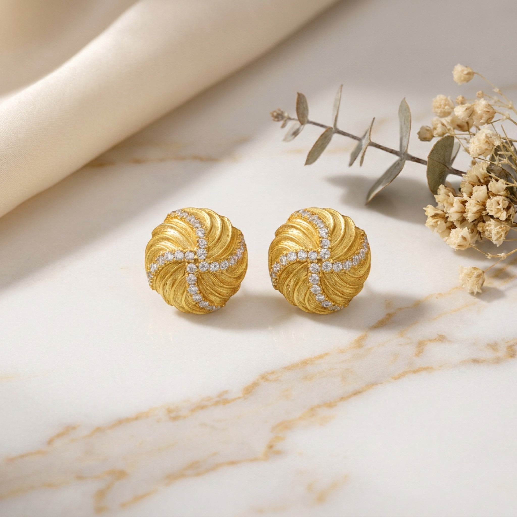 Tania Claire Australia Solaris Studs: 14K gold plated sterling silver earrings with swirling texture and pavé crystals.