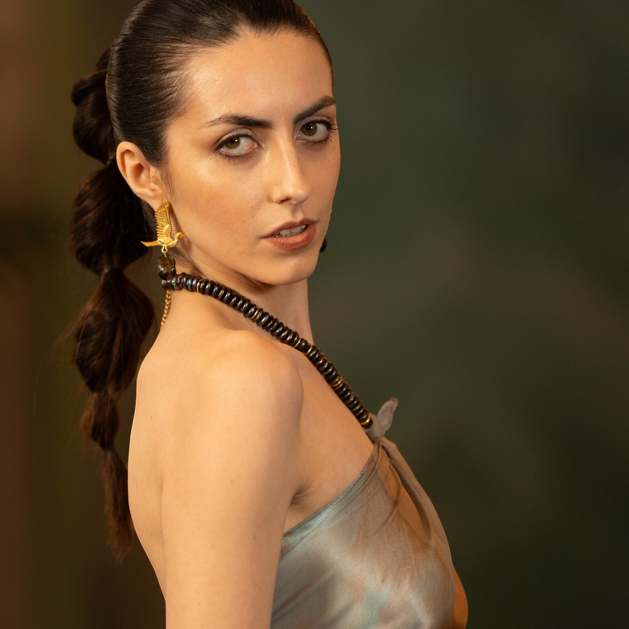 Tania Claire Australia gold-tone winged bird earrings with black baroque pearl drops. Sculptural drop design.