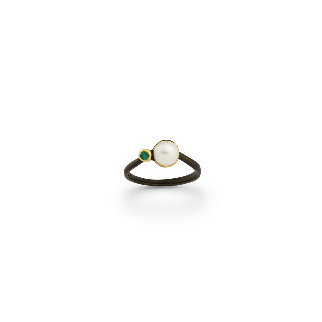 A sterling silver ring plated in 22K yellow gold and black rhodium, featuring a freshwater pearl and a green emerald.