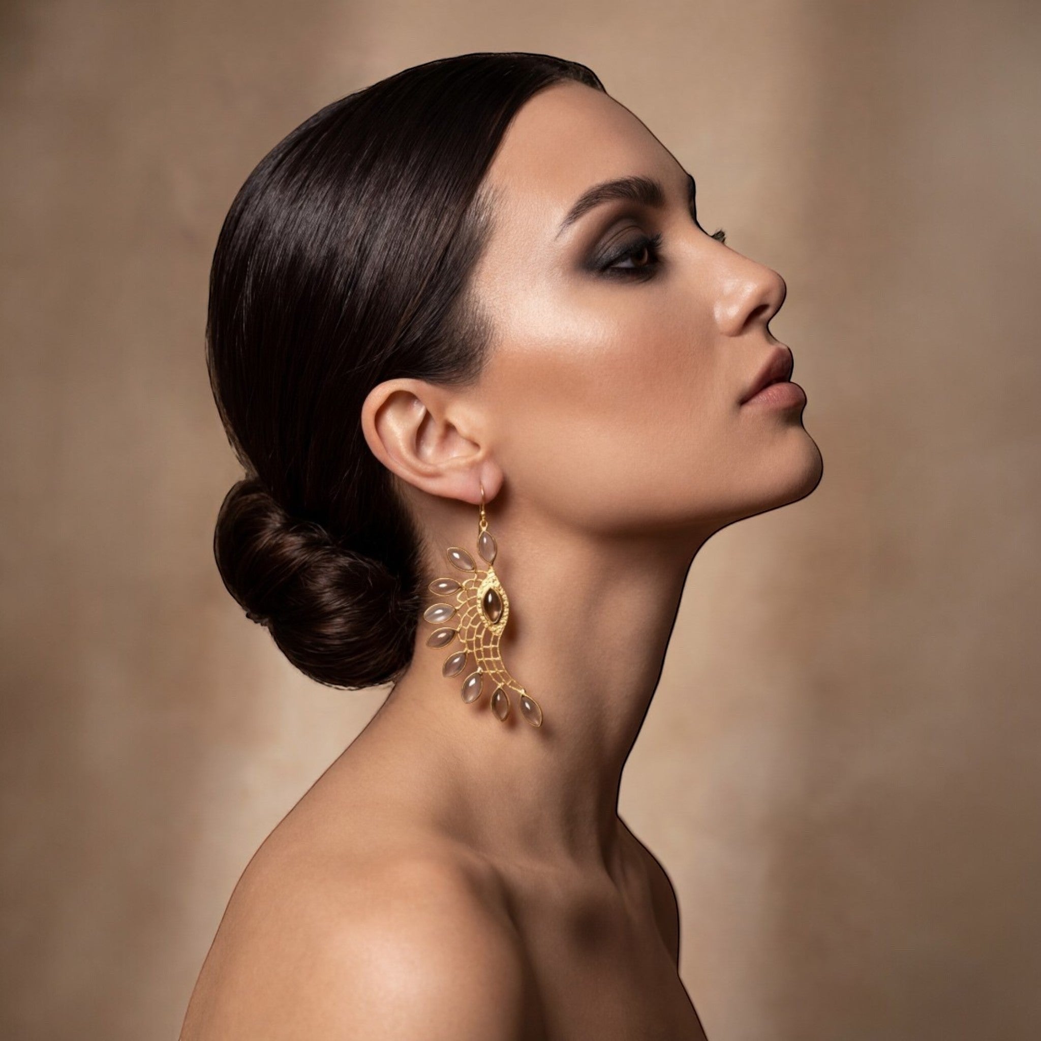 Tania Claire Australia gold-plated wing earrings with smoky quartz stones and intricate lattice work.