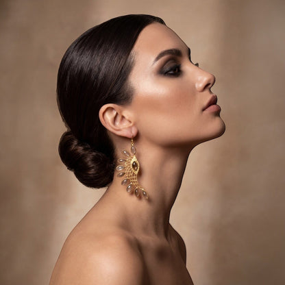Tania Claire Australia gold-plated wing earrings with smoky quartz stones and intricate lattice work.