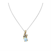 A sterling silver necklace with a 22K yellow gold plate and a drop-shaped sky blue topaz pendant, accompanied by small round blue sapphire gemstones.