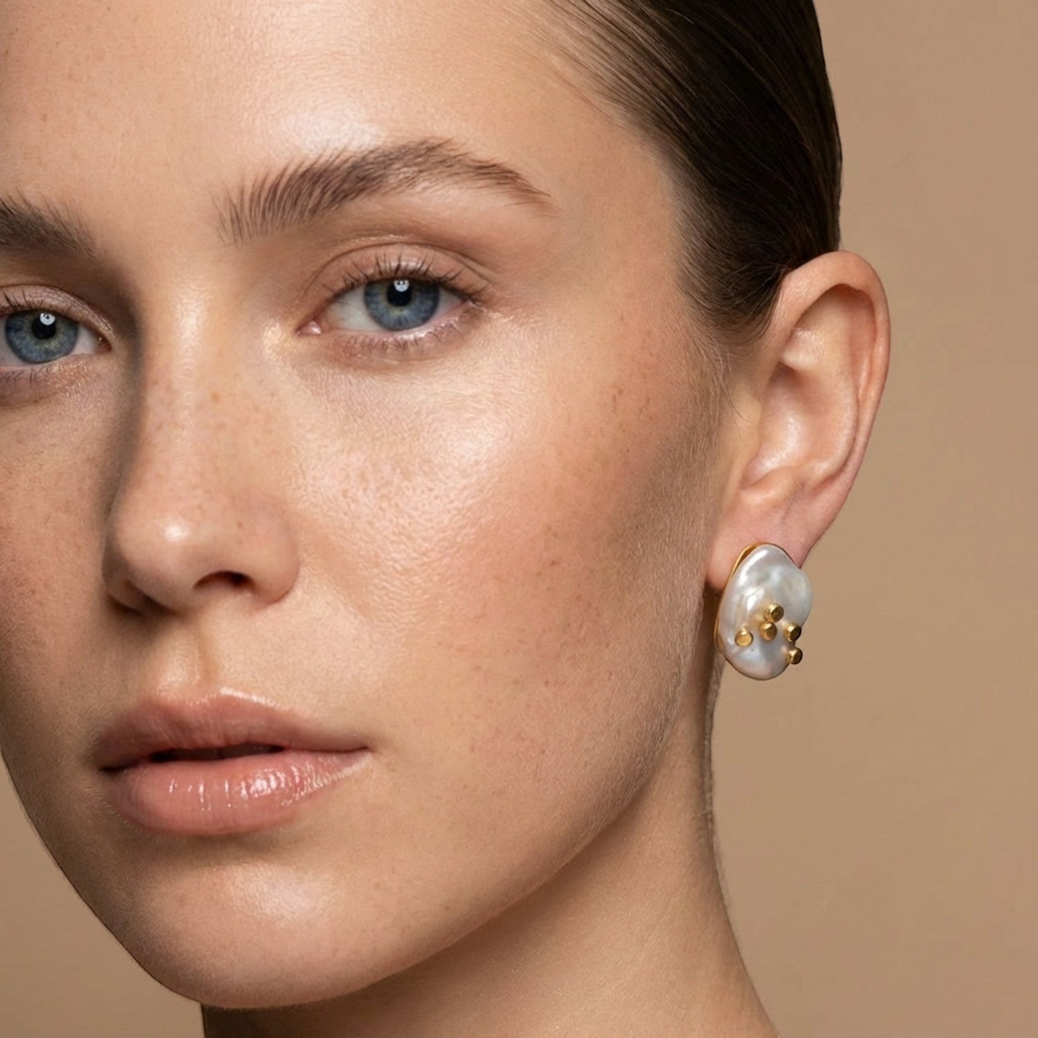 Tania Claire Australia Tide Mark earrings feature asymmetrical baroque pearls with 14K gold plated brass accents.