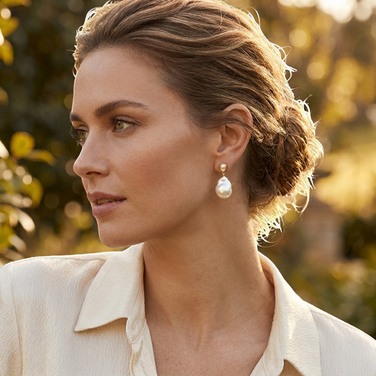 Tania Claire Australia Mae pearl drop studs featuring organic baroque pearls in a polished gold-tone setting on a model