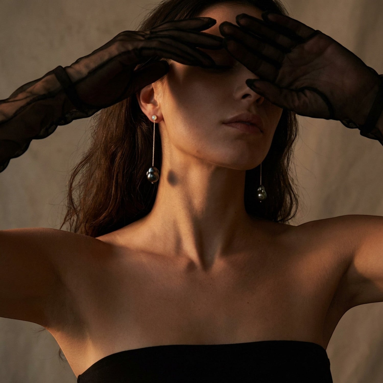 Tania Claire Australia Wren black pearl drop earrings with gold chain and white opal detail.