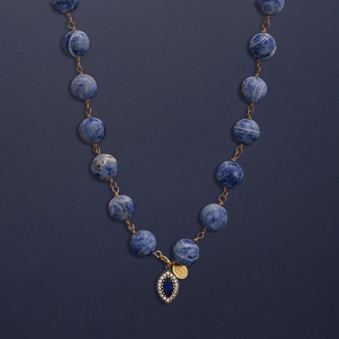 Tania Claire Australia Bleu Royale necklace with marbled sodalite beads and a sapphire pendant framed with crystals.