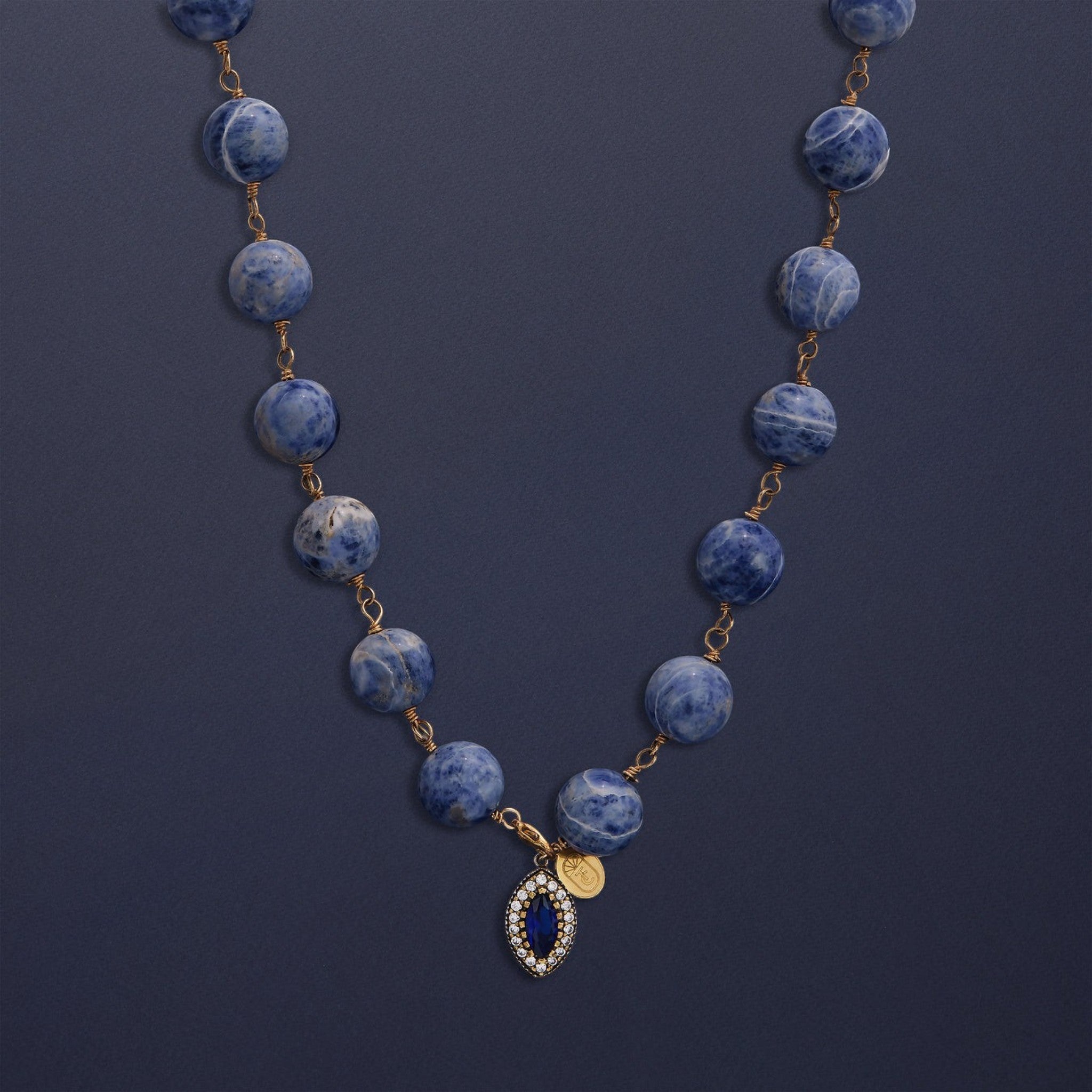 Tania Claire Australia Bleu Royale necklace with marbled sodalite beads and a sapphire pendant framed with crystals.