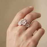 Tania Claire Australia Blossom Ring: Sterling silver floral ring with white enamel petals, pink sapphires, and rose gold accents.