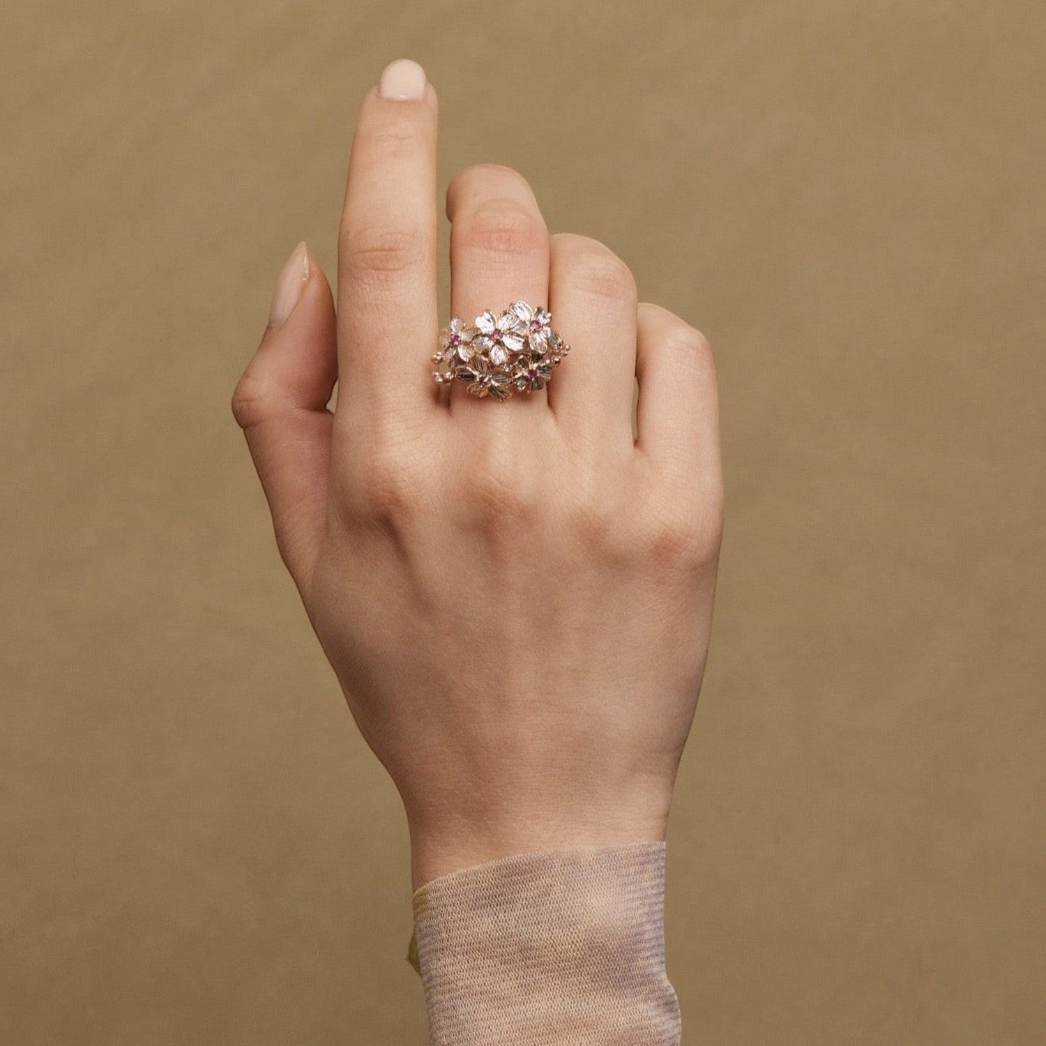 Tania Claire Australia Blossom Ring: Sterling silver floral ring with rose gold plating, pink sapphires, and silver accents.