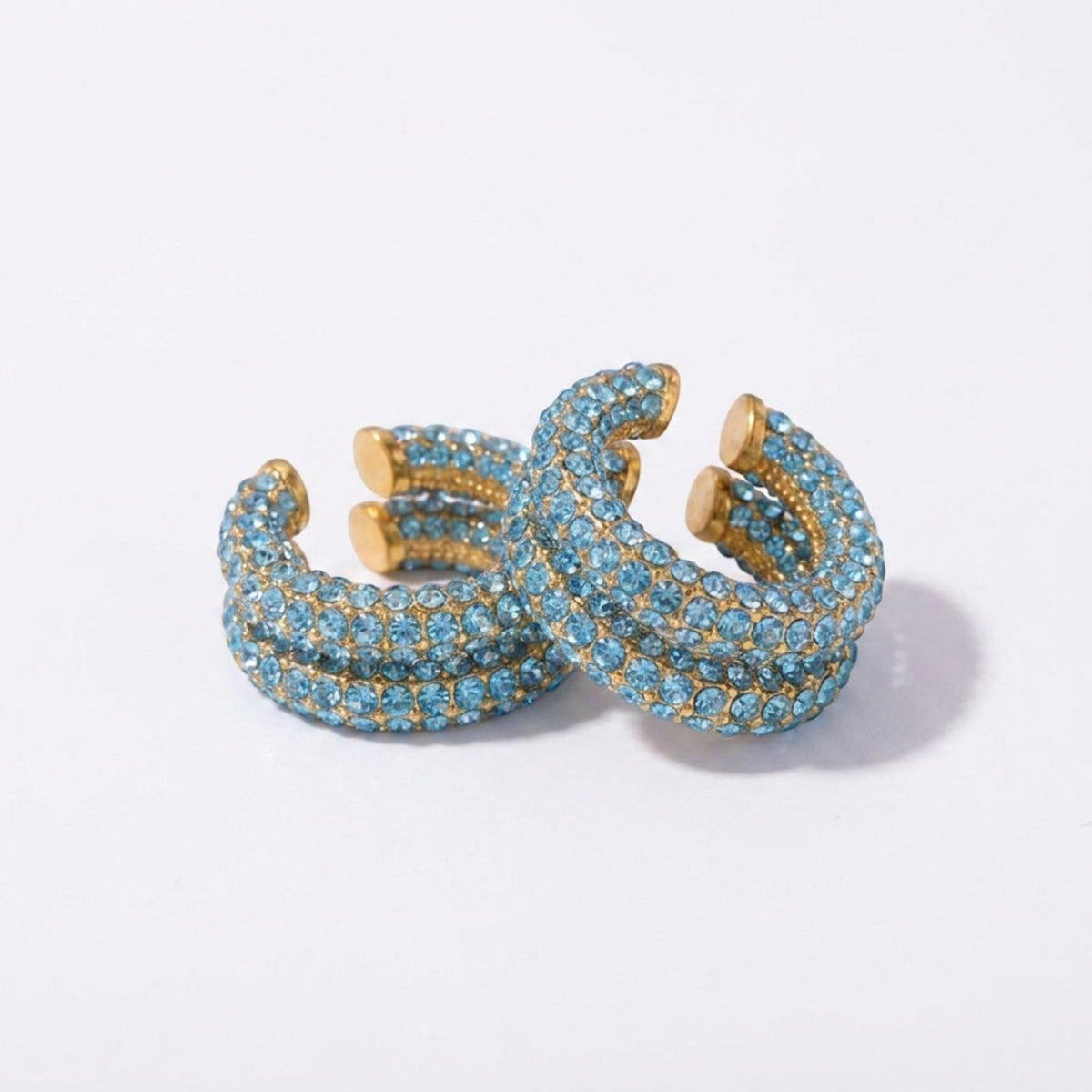 Tania Claire Australia Fluer Cuffs featuring light blue rhinestones on a gold-tone band for non-pierced ears.