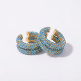 Tania Claire Australia Fluer Cuffs featuring light blue rhinestones on a gold-tone band for non-pierced ears.
