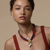 Tania Claire Australia Ember Tide necklace with red coral, lapis lazuli beads, gold clasp, and pearl drops.