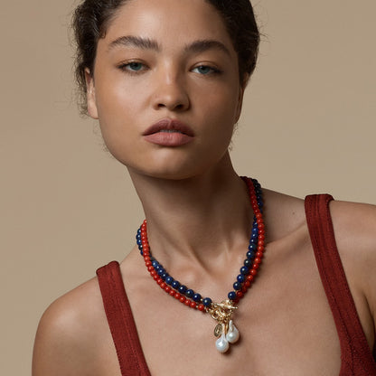 Tania Claire Australia Ember Tide necklace with red coral, lapis lazuli beads, gold clasp, and pearl drops.