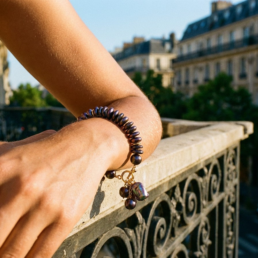 Tania Claire Australia Étoile Noir Bracelet with iridescent midnight freshwater pearls and baroque pearl charms on a gold clasp.