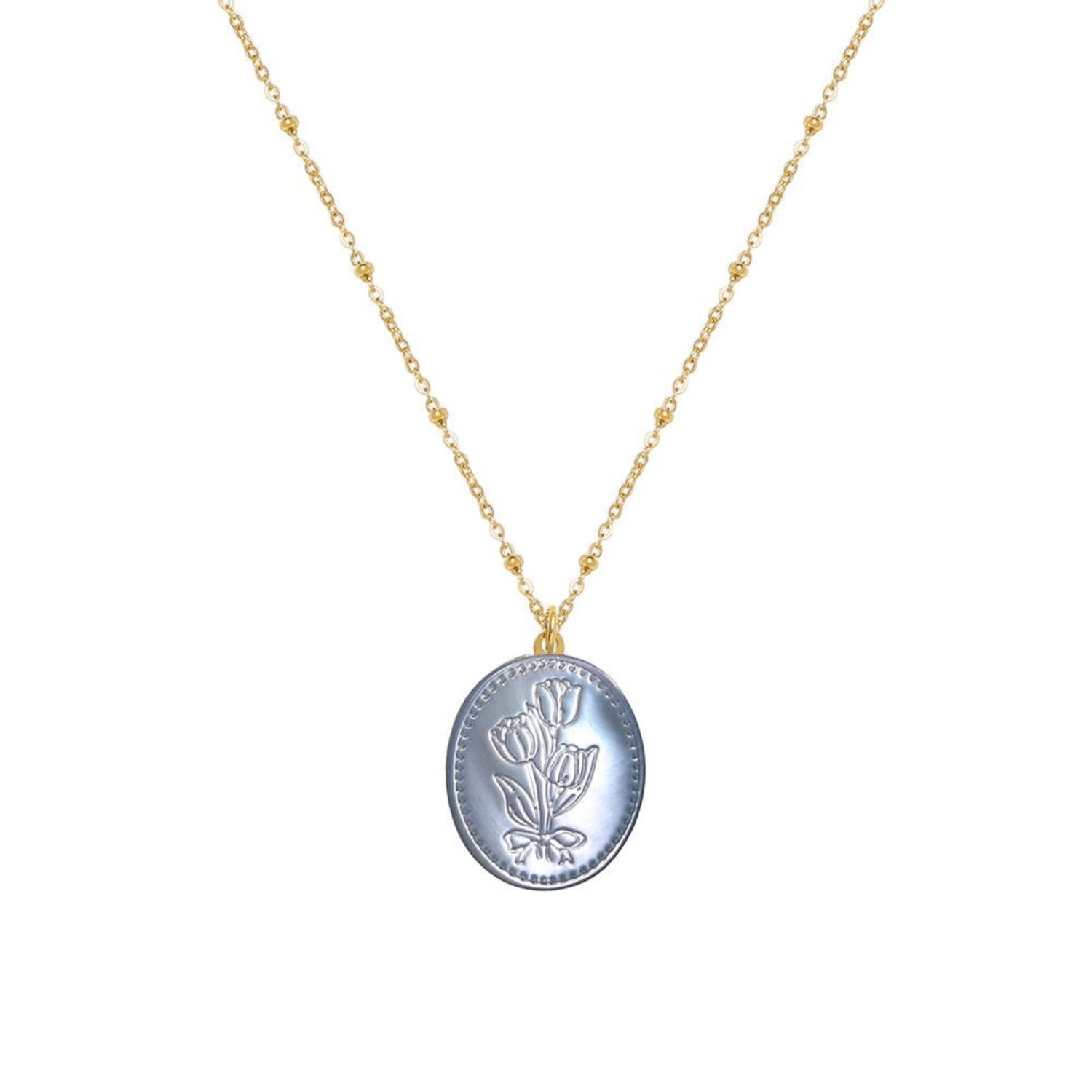 Tania Claire Australia Flora Necklace: gold-plated chain with bead accents and oval pendant featuring embossed floral motif in pastel blue.