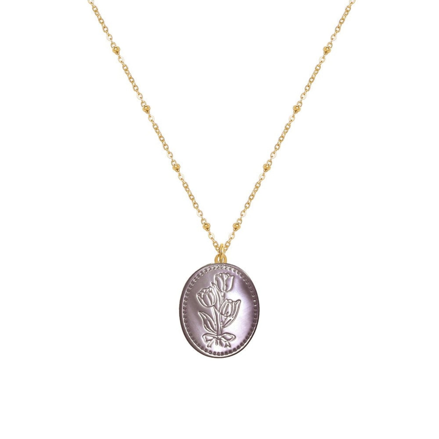 Tania Claire Australia Flora Necklace: gold-plated chain with bead accents and oval pendant featuring embossed floral motif and bow.