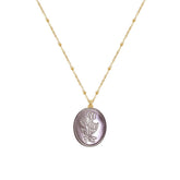 Tania Claire Australia Flora Necklace: gold-plated chain with bead accents and oval pendant featuring embossed floral motif and bow.
