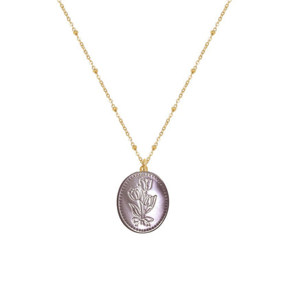 Tania Claire Australia Flora Necklace: gold-plated chain with bead accents and oval pendant featuring embossed floral motif and bow.