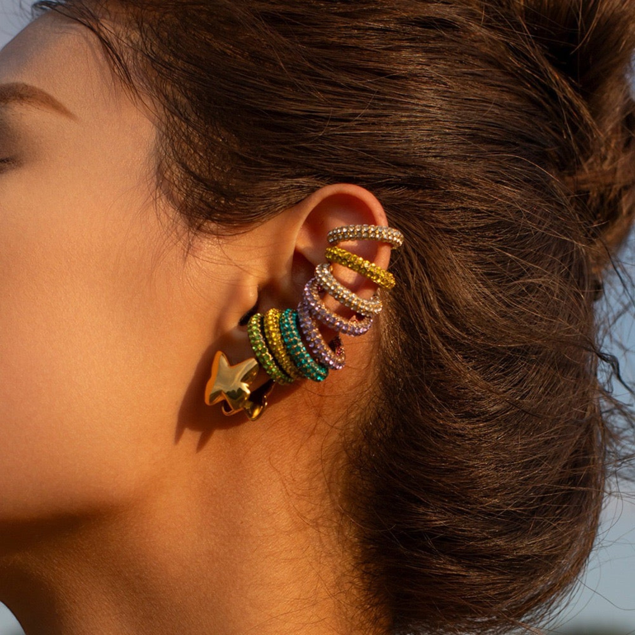 Tania Claire Australia Fluer Cuffs ear cuffs adorned with colorful rhinestones and a gold star charm.