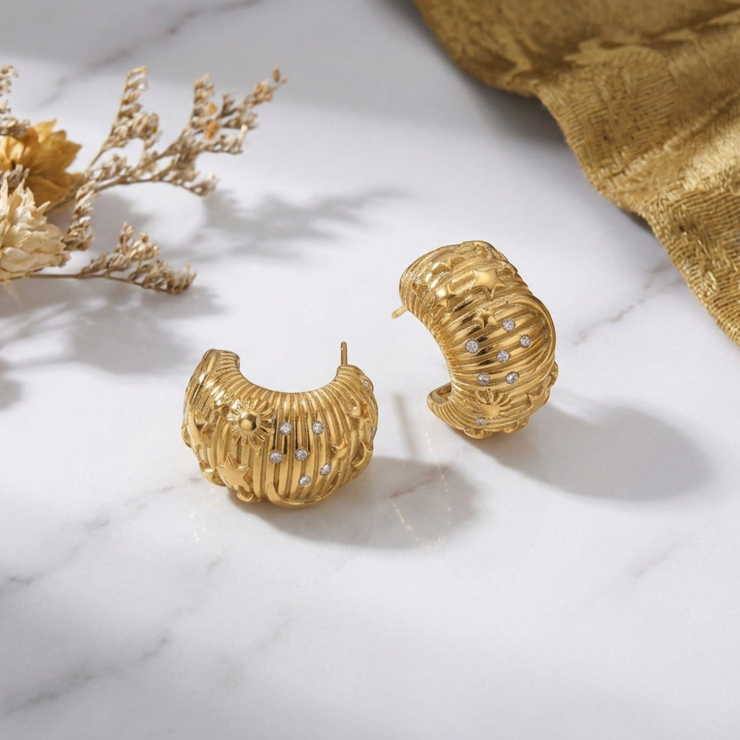 Tania Claire Australia gold-plated textured galaxy hoop earrings with cubic zirconia stones.
