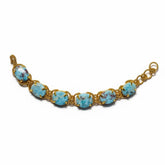 Tania Claire Australia Holly Gemstone Twist Bracelet with cabochon cut blue gemstones and gold plating.