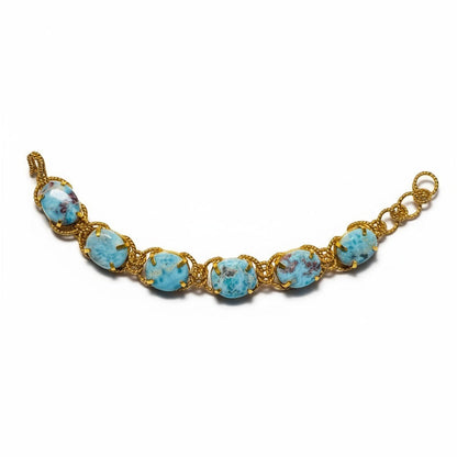 Tania Claire Australia Holly Gemstone Twist Bracelet with cabochon cut blue gemstones and gold plating.