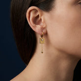 Tania Claire Australia gold-plated hoop earrings with square charm, cubic zirconia and dangling bead.