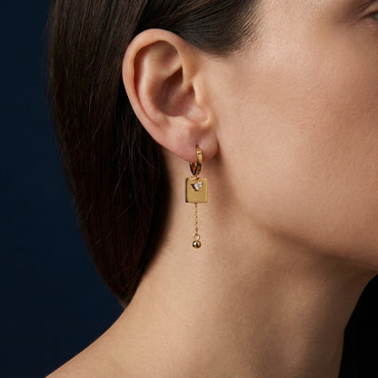 Tania Claire Australia gold-plated hoop earrings with square charm, cubic zirconia and dangling bead.