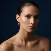 Tania Claire Australia gold-plated hoop earrings with a square charm, cubic zirconia, and dangling chain.