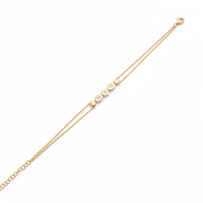 Tania Claire Australia gold double chain bracelet with five circular charms, three set with sparkling stones.