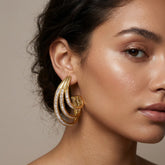 Tania Claire Australia Aurelia Arc gold-tone sculptural statement earrings with crystal pavé accents.