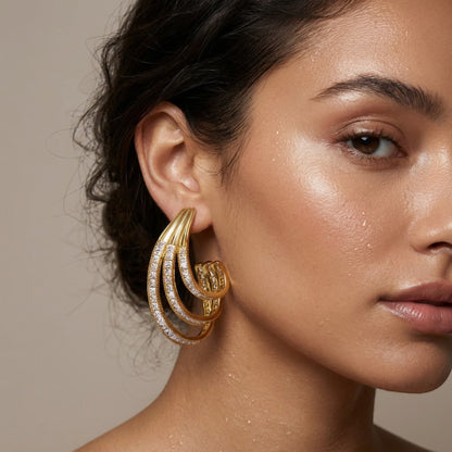Tania Claire Australia Aurelia Arc gold-tone sculptural statement earrings with crystal pavé accents.