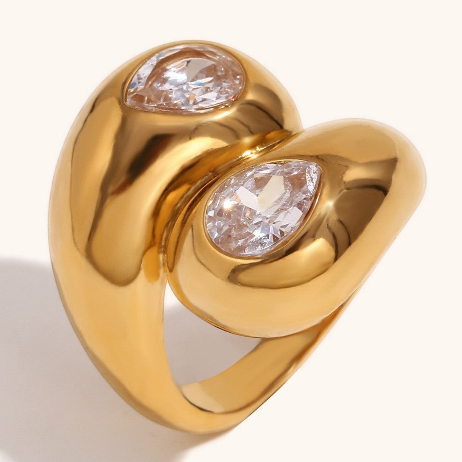 Tania Claire Australia gold ring featuring two teardrop-shaped clear crystals in a polished chunky bypass design