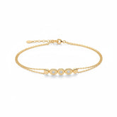 Tania Claire Australia gold bracelet with double chain and three sparkling stones set in oval gold bezels.