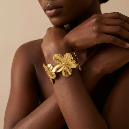 Tania Claire Australia gold Frangipani cuff bracelet with textured floral petals and open cuff design.