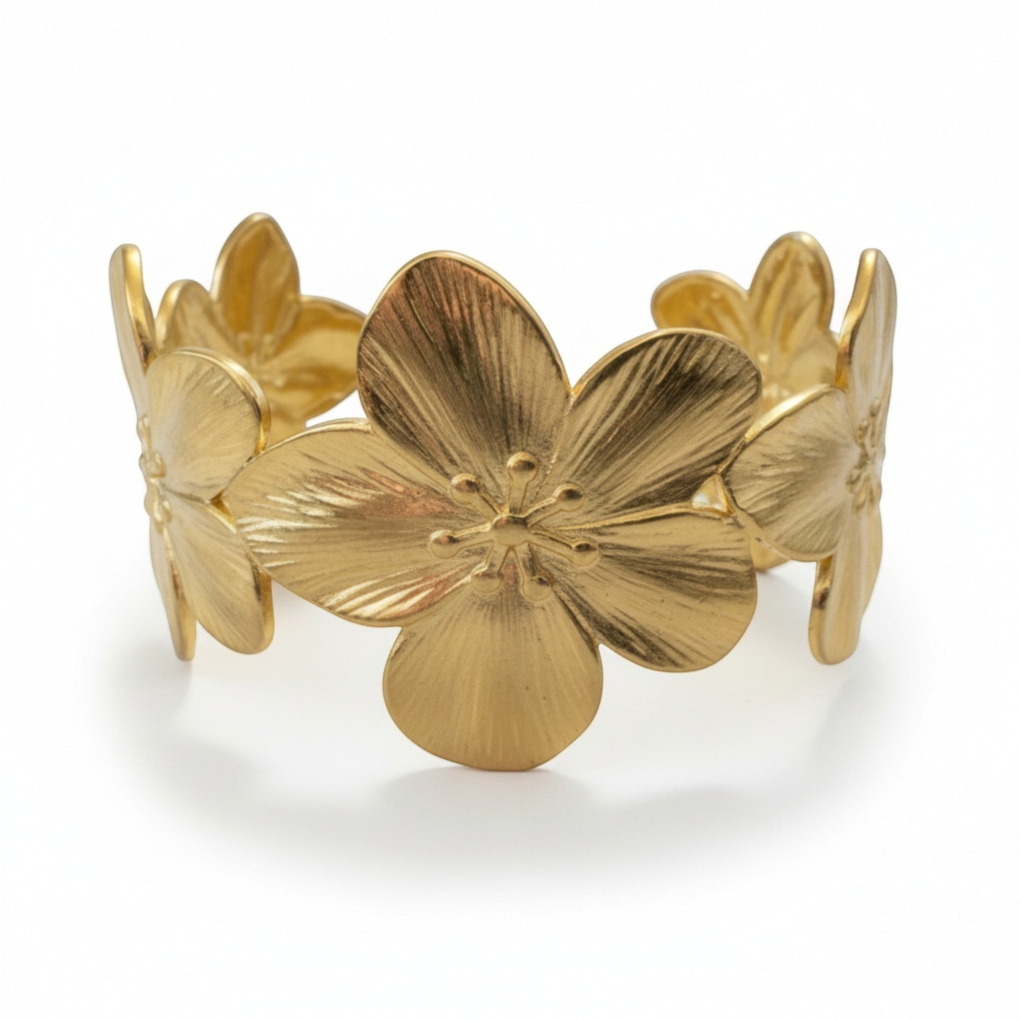 Tania Claire Australia gold frangipani flower cuff bracelet with textured petals and open back.