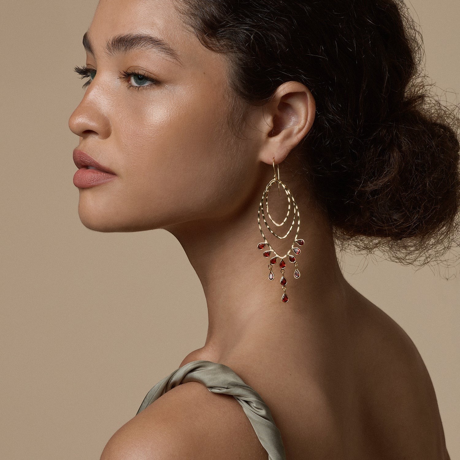 Tania Claire Australia Desert Dancer gold finish sterling silver earrings with garnet drops.