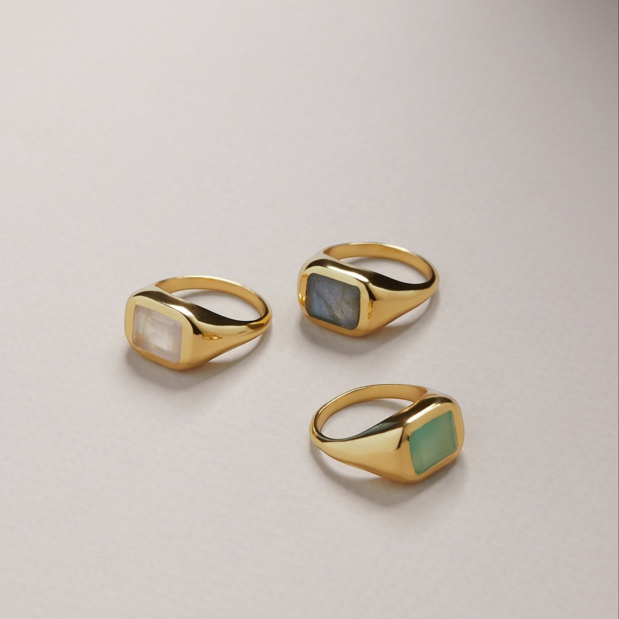 Tania Claire Australia gold signet rings with rectangular gemstones: moonstone, labradorite, and green chalcedony.