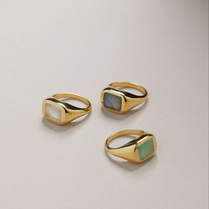 Tania Claire Australia gold signet rings with rectangular gemstones: moonstone, labradorite, and green chalcedony.