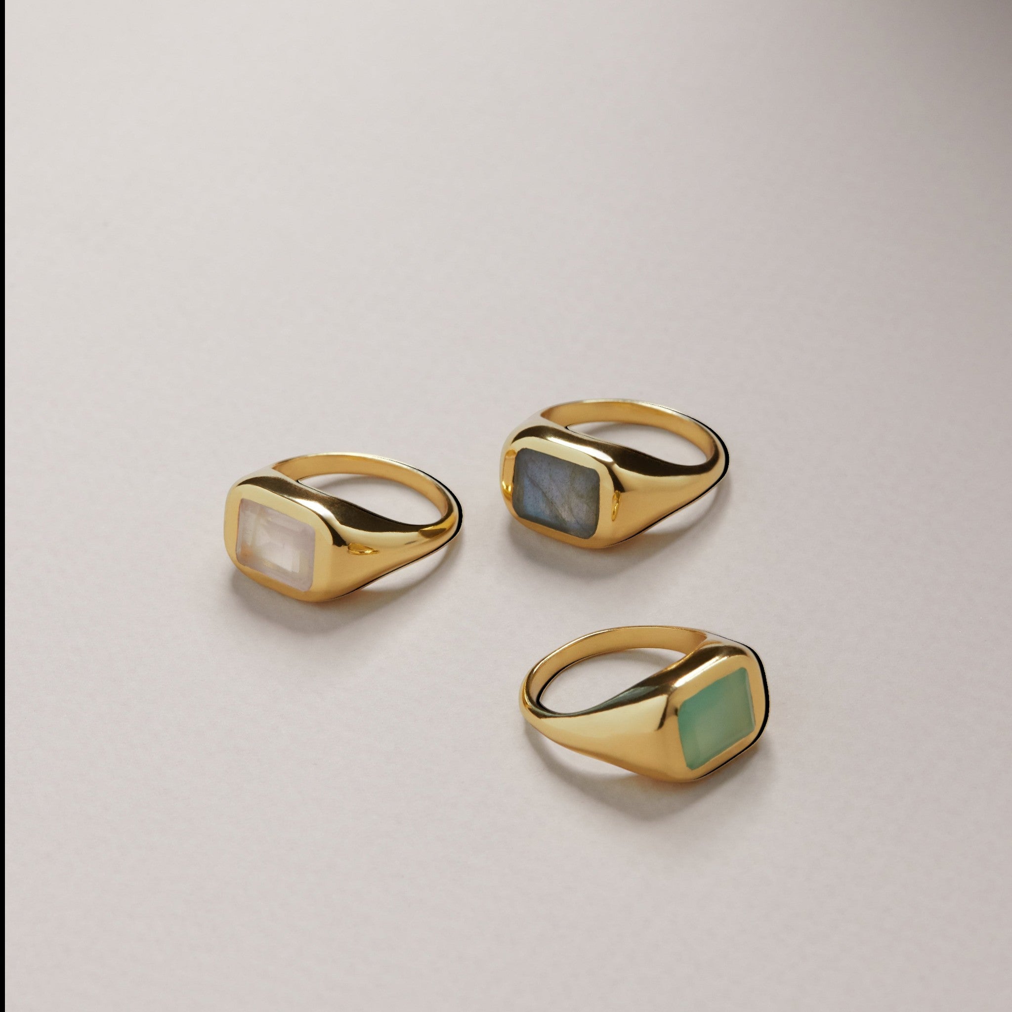 Tania Claire Australia gold signet ring with a rectangular rose quartz gemstone. Modern sculptural design.