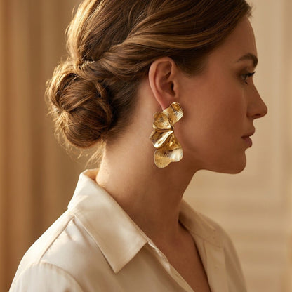 Tania Claire Australia Dryas Crest gold leaf earrings worn by a woman in profile, featuring sculptural ribbed texture.