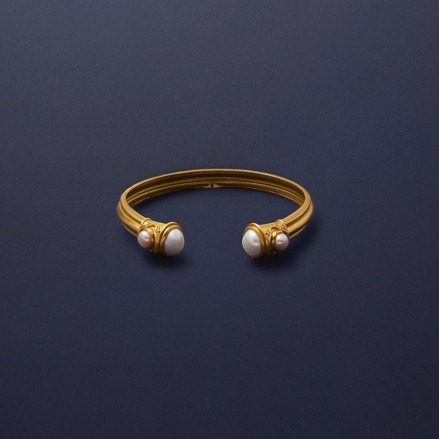 Tania Claire Australia gold cuff bracelet with freshwater pearl accents. Open cuff design with sculptural details.