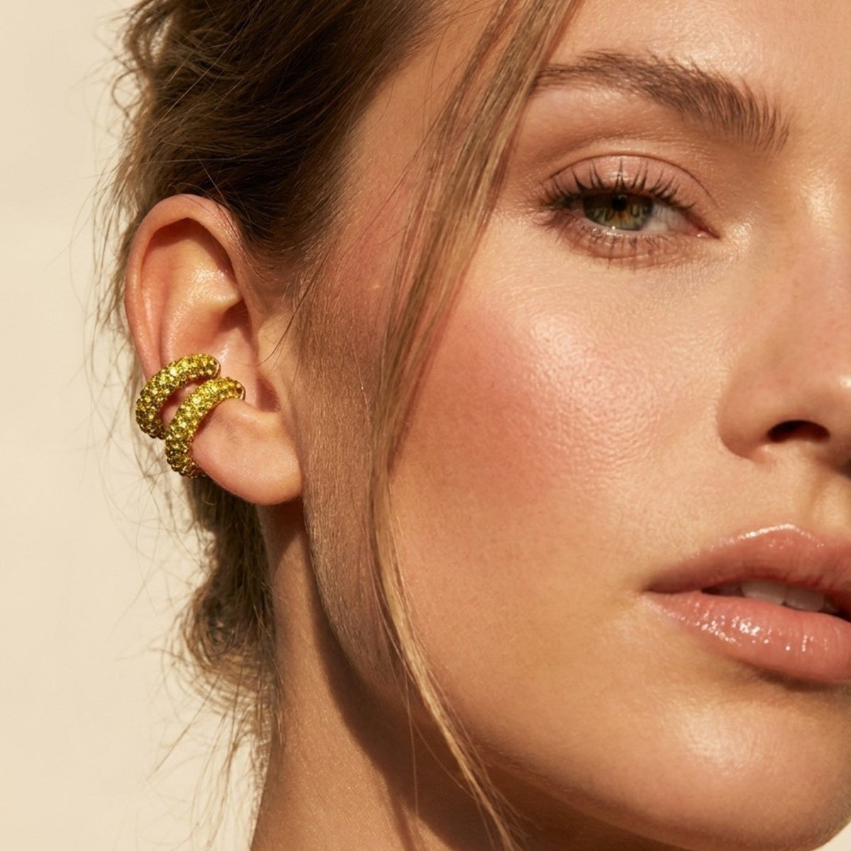 Tania Claire Australia gold rhinestone ear cuffs worn on a model, adding sparkle to an elegant everyday look.